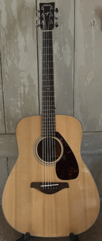 Acoustic Guitar against a painted wood background